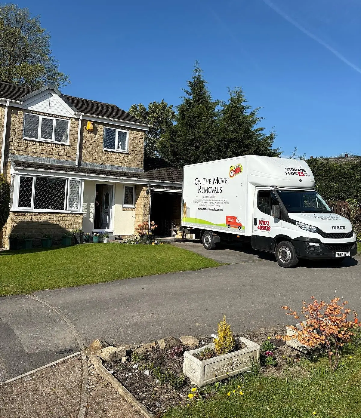 picture of on the move removals vans outside a house