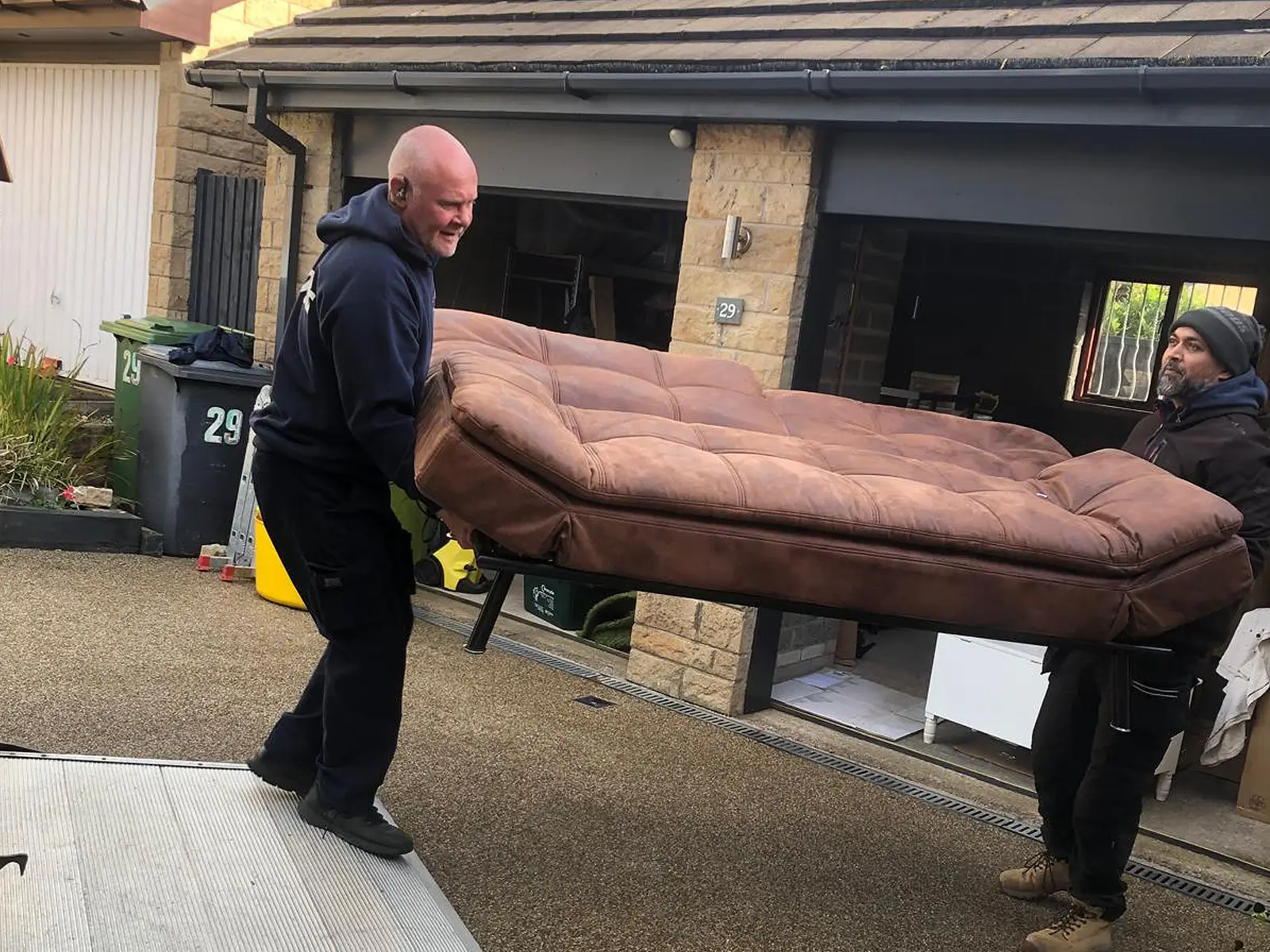 picture of on move removals carrying a sofa on van tailgate