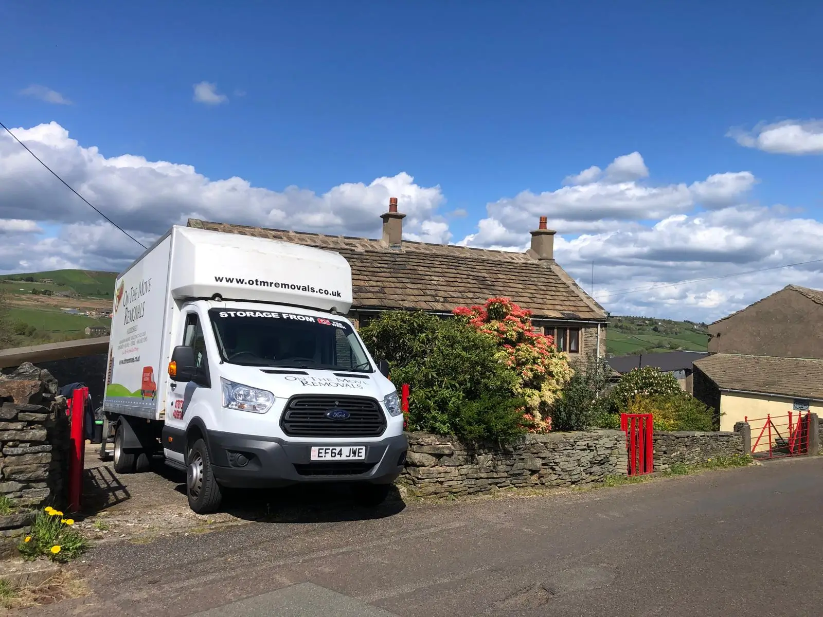 On The Move Removals van parked outside a stone countryside cottage near Waterloo, Huddersfield