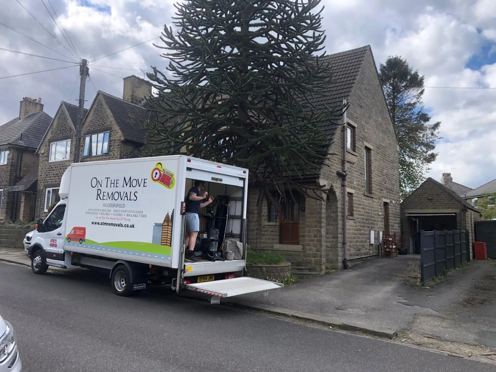 On The Move Removals van outside a Lepton semi-detached home with the team loading items into the van