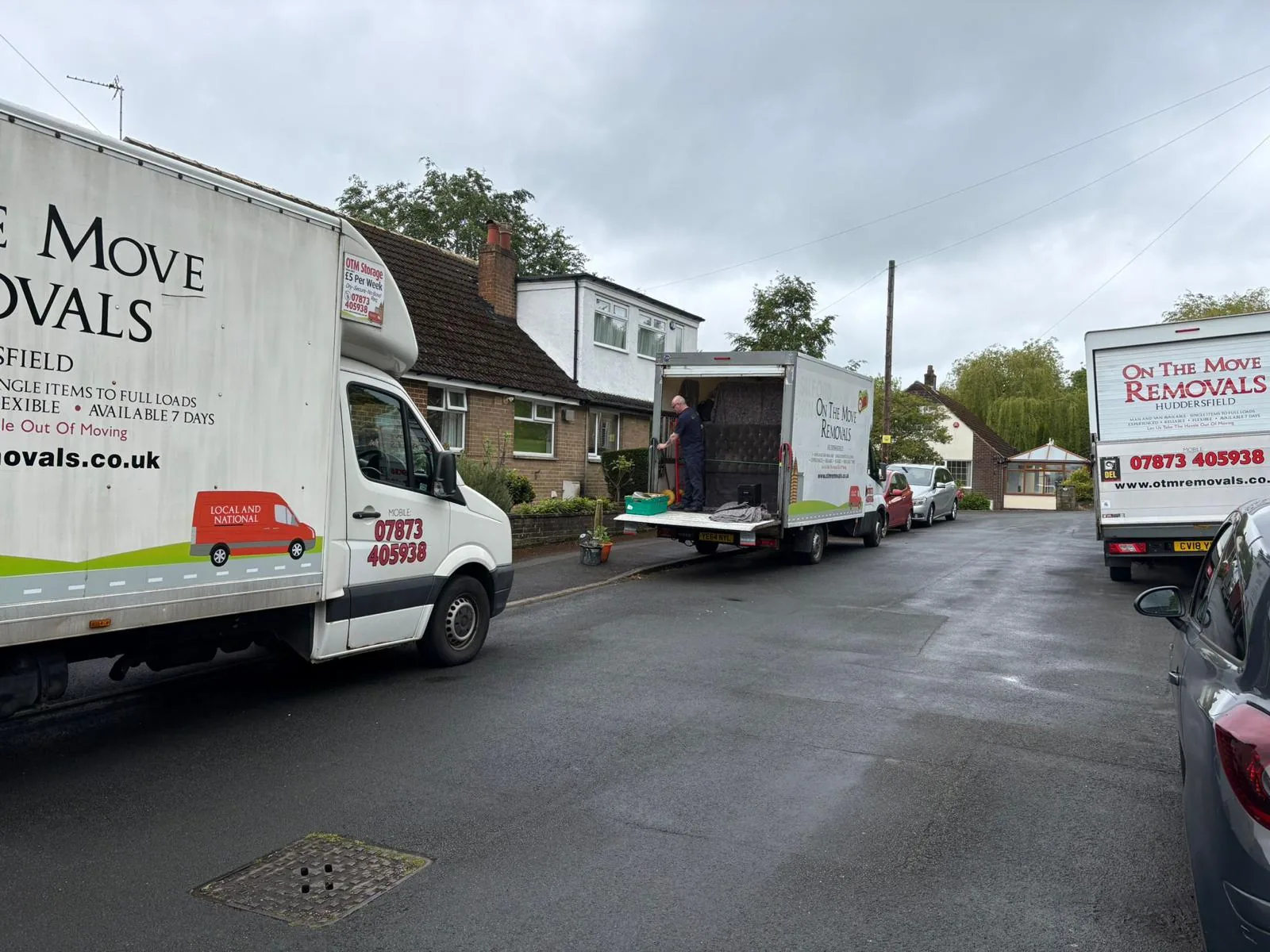 Two On The Move Removals vans on a residential street in Crosland Moor, Huddersfield for a local moving job