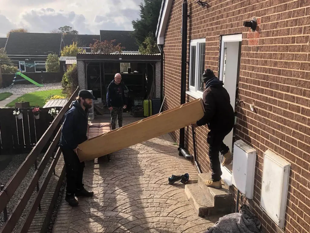 picture of on move removals guys moving furniture out of a house